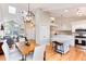 Open-concept layout with dining area, kitchen island with seating, and inviting living area at 9742 Burntwood Ct, Highlands Ranch, CO 80126