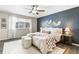 Primary bedroom features luxury vinyl flooring, natural light, decorative fixtures and dark accent wall at 11761 Cord Grass Way, Parker, CO 80138