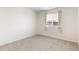 Cozy bedroom features a window with curtains and neutral carpet at 11761 Cord Grass Way, Parker, CO 80138