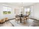 Dining room features a modern table, new fixtures, luxury vinyl flooring, and natural light at 11761 Cord Grass Way, Parker, CO 80138