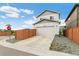 Two-story home with attached garage and fenced-in yard, providing privacy and curb appeal at 11761 Cord Grass Way, Parker, CO 80138
