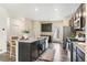 Bright kitchen features granite counters, stainless steel appliances, dark cabinets and recessed lighting at 11761 Cord Grass Way, Parker, CO 80138