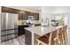 Spacious kitchen island with barstool seating, stainless steel appliances, and abundant counter space for meal preparation at 11761 Cord Grass Way, Parker, CO 80138