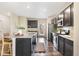Bright kitchen features granite counters, stainless steel appliances, dark cabinets and opens to the backyard at 11761 Cord Grass Way, Parker, CO 80138