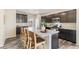 Open kitchen features granite counters, stainless steel appliances, and a large center island with seating at 11761 Cord Grass Way, Parker, CO 80138