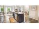 Modern kitchen with dark cabinets, island with seating, stainless steel appliances and luxury vinyl flooring at 11761 Cord Grass Way, Parker, CO 80138