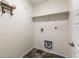 Laundry room featuring open shelving, utility connections, and tile flooring at 11761 Cord Grass Way, Parker, CO 80138