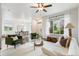 Bright living room featuring a large window, ceiling fan, hardwood floors, and comfortable seating arrangement at 11761 Cord Grass Way, Parker, CO 80138
