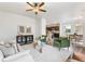 Open concept living room showcasing stylish decor, neutral tones, and seamless flow into the dining and kitchen areas at 11761 Cord Grass Way, Parker, CO 80138