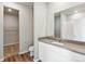 Modern bathroom boasts a large vanity, sink, a big mirror, and an accessible walk-in shower at 2986 Oxley St, Strasburg, CO 80136