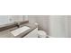 Modern bathroom vanity with light countertop, white cabinetry, and brushed chrome faucet at 2986 Oxley St, Strasburg, CO 80136