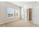 Light-filled bedroom with plush carpeting, two windows with blinds, and a closet at 2986 Oxley St, Strasburg, CO 80136
