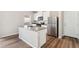Bright kitchen featuring a center island, stainless steel appliances, and abundant cabinet space at 2986 Oxley St, Strasburg, CO 80136