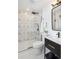 Modern bathroom featuring a glass shower enclosure, black fixtures, toilet, and modern sink at 3091 S Krameria St, Denver, CO 80222