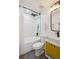 Bright bathroom featuring a tub with herringbone tile, black fixtures, and a modern yellow vanity at 3091 S Krameria St, Denver, CO 80222