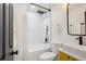 Bathroom featuring tub with white tile surround, modern vanity and black fixtures at 3091 S Krameria St, Denver, CO 80222