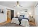 Relaxing bedroom features a ceiling fan, two windows, and ensuite closet at 3091 S Krameria St, Denver, CO 80222