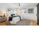 Well lit main bedroom with ceiling fan, two windows and hardwood flooring at 3091 S Krameria St, Denver, CO 80222