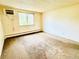 Carpeted bedroom with large window and white walls at 8826 E Florida Ave # 102, Denver, CO 80247