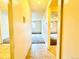 Hallway with tile and carpet flooring leading into the living room at 8826 E Florida Ave # 102, Denver, CO 80247