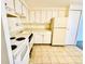 Kitchen with white appliances, tile flooring, and cabinetry at 8826 E Florida Ave # 102, Denver, CO 80247