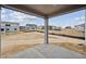 View from covered patio looking into the large backyard of a newly constructed home at 12353 E 101St Pl, Commerce City, CO 80022