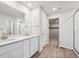 Bright bathroom with double vanity, quartz countertop, and walk-in shower at 12353 E 101St Pl, Commerce City, CO 80022