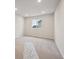 Bright bedroom with a large window, neutral carpet, and fresh paint at 12353 E 101St Pl, Commerce City, CO 80022