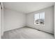Bedroom with natural light and a view of the neighborhood from the large window at 12353 E 101St Pl, Commerce City, CO 80022