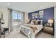 Bedroom with a blue accent wall, plush carpet, and decorative lighting at 12353 E 101St Pl, Commerce City, CO 80022