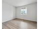 Bright bedroom with hardwood floors and a large window offering ample natural light at 12353 E 101St Pl, Commerce City, CO 80022