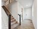 Inviting entryway with hardwood floors and a staircase, leading to the upper level of the home at 12353 E 101St Pl, Commerce City, CO 80022