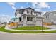 Beautiful two-story home with gray siding, complemented by a well-kept lawn and attached two car garage at 12353 E 101St Pl, Commerce City, CO 80022