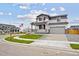 Attractive two-story home with a welcoming front porch, showcasing well-maintained landscaping and a two-car garage at 12353 E 101St Pl, Commerce City, CO 80022