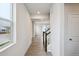 Hallway with wood floors, white walls, and lots of natural light from the window at 12353 E 101St Pl, Commerce City, CO 80022
