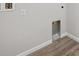 Bright laundry room showcasing hardwood floors and modern hookups at 12353 E 101St Pl, Commerce City, CO 80022