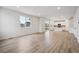 Spacious living room with hardwood floors, sliding glass doors, and an open layout, leading to the kitchen at 12353 E 101St Pl, Commerce City, CO 80022
