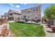 Expansive backyard with a lush lawn, a patio with outdoor seating, and a well-maintained fence for privacy at 1673 Morningview Ln, Castle Rock, CO 80109