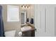 Compact bathroom featuring a toilet, vanity with sink, and mirrored cabinet with vanity lighting at 1673 Morningview Ln, Castle Rock, CO 80109