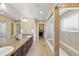 Bright bathroom featuring double vanities and a walk-in shower at 1673 Morningview Ln, Castle Rock, CO 80109