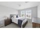 Bright bedroom featuring a queen-size bed, neutral colors, and two windows offering plenty of natural light at 1673 Morningview Ln, Castle Rock, CO 80109