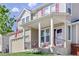 Inviting two-story home featuring a covered front porch and a well-maintained lawn at 1673 Morningview Ln, Castle Rock, CO 80109