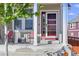Charming front porch featuring a red door, railing, and space for outdoor seating at 1673 Morningview Ln, Castle Rock, CO 80109