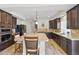 Stylish kitchen featuring dark wood cabinets, granite counters, and stainless steel appliances at 1673 Morningview Ln, Castle Rock, CO 80109