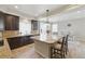 Modern kitchen with dark cabinetry, granite countertops, island, and bar stool seating at 1673 Morningview Ln, Castle Rock, CO 80109