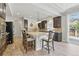 Spacious kitchen island with granite countertop, seating for three, and pendant lighting at 1673 Morningview Ln, Castle Rock, CO 80109