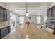 Expansive kitchen island with granite countertop, seating, and pendant lighting at 1673 Morningview Ln, Castle Rock, CO 80109