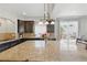 A spacious kitchen with a central island and view of outdoor patio at 1673 Morningview Ln, Castle Rock, CO 80109