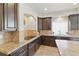 Elegant kitchen featuring granite countertops and rich, dark wood cabinetry at 1673 Morningview Ln, Castle Rock, CO 80109