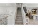 Carpeted staircase leading to the upper level with white banisters and open floor plan at 1673 Morningview Ln, Castle Rock, CO 80109